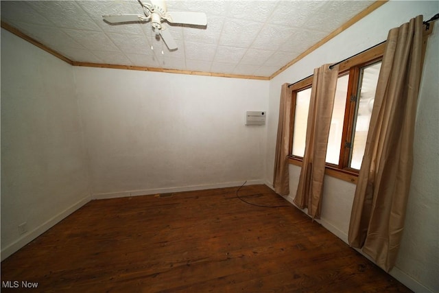 interior space featuring ornamental molding, ceiling fan, and dark hardwood / wood-style flooring