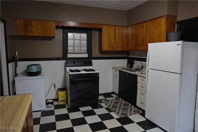 kitchen with refrigerator, gas range oven, sink, and white fridge