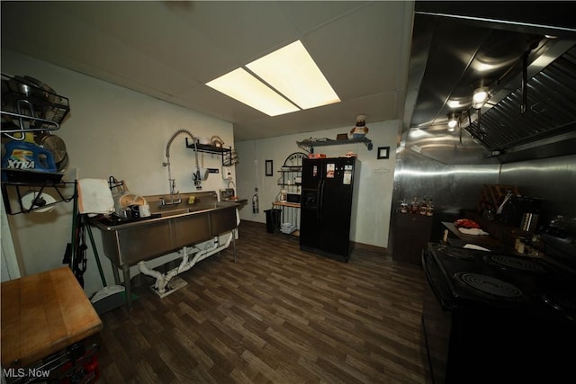 interior space with dark hardwood / wood-style floors and black appliances