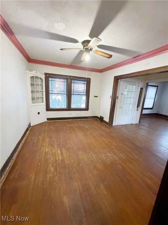 unfurnished room with hardwood / wood-style flooring, ceiling fan, and crown molding