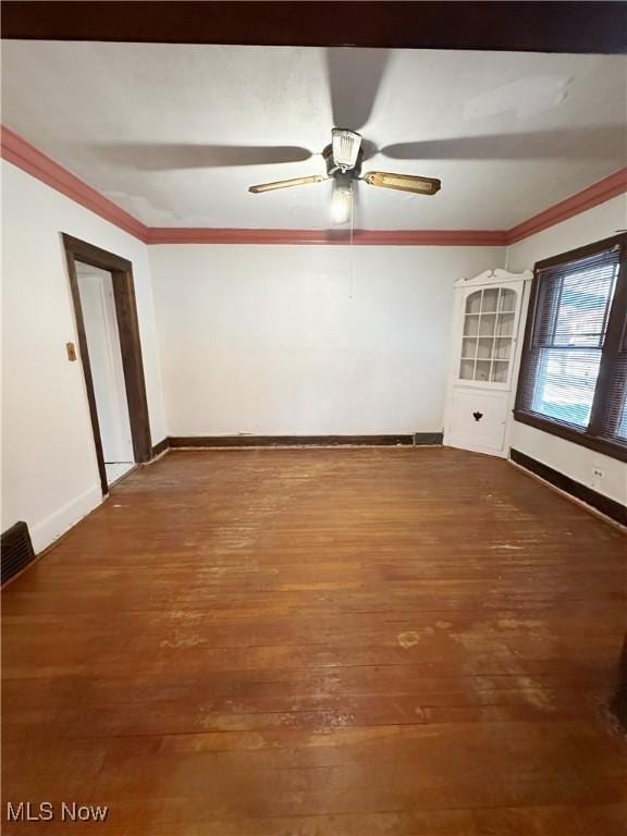 empty room with crown molding, ceiling fan, and wood-type flooring