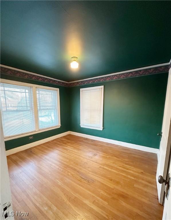 empty room with hardwood / wood-style flooring