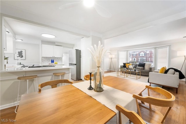 dining area featuring light hardwood / wood-style floors and ceiling fan