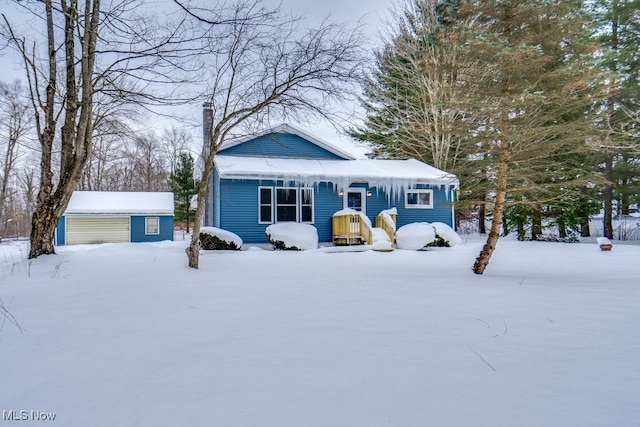 bungalow-style home with a storage shed