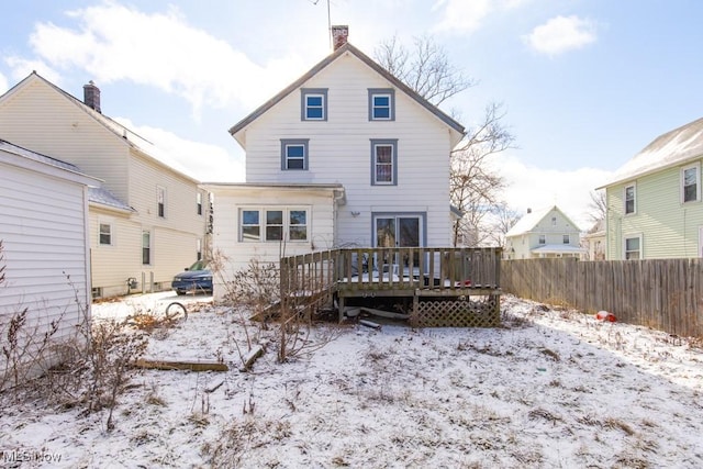 snow covered property with a deck