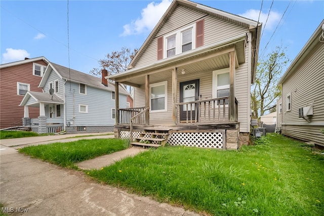 bungalow-style house with covered porch and a front yard