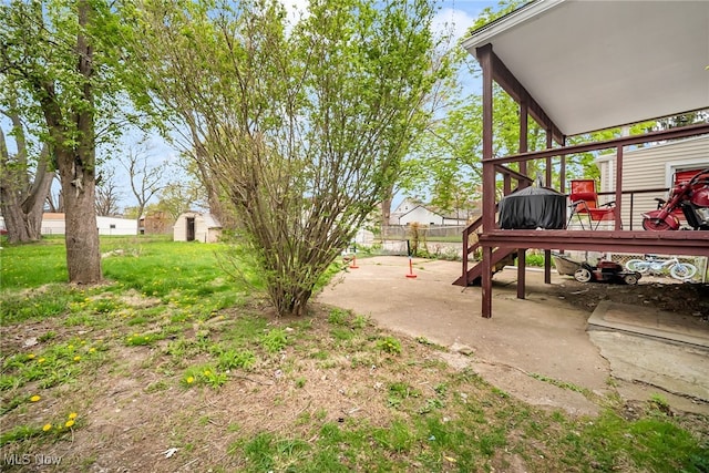 view of yard with a deck and fence