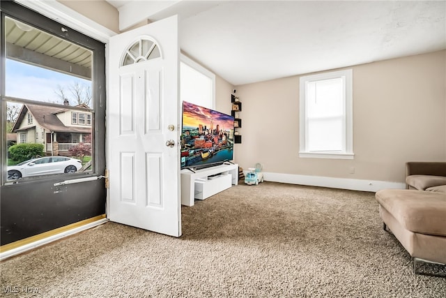 sitting room featuring a healthy amount of sunlight, carpet flooring, and baseboards