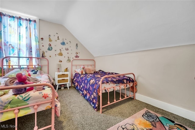 bedroom with vaulted ceiling, carpet floors, and baseboards
