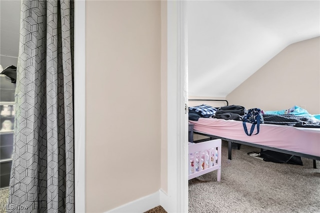 interior space with vaulted ceiling and baseboards