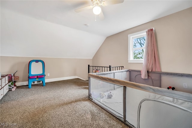 unfurnished bedroom with lofted ceiling, a ceiling fan, carpet, and baseboards