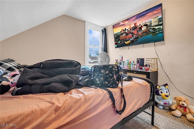 bedroom with vaulted ceiling and carpet floors