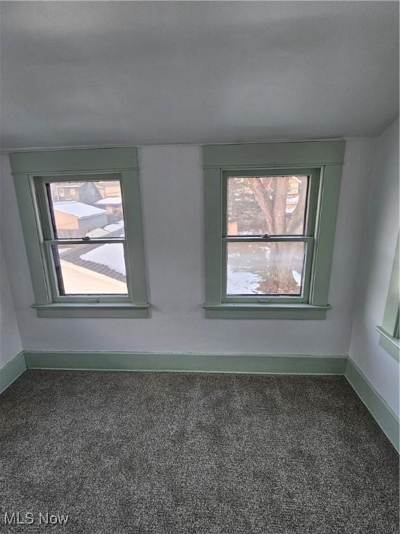 carpeted empty room featuring plenty of natural light