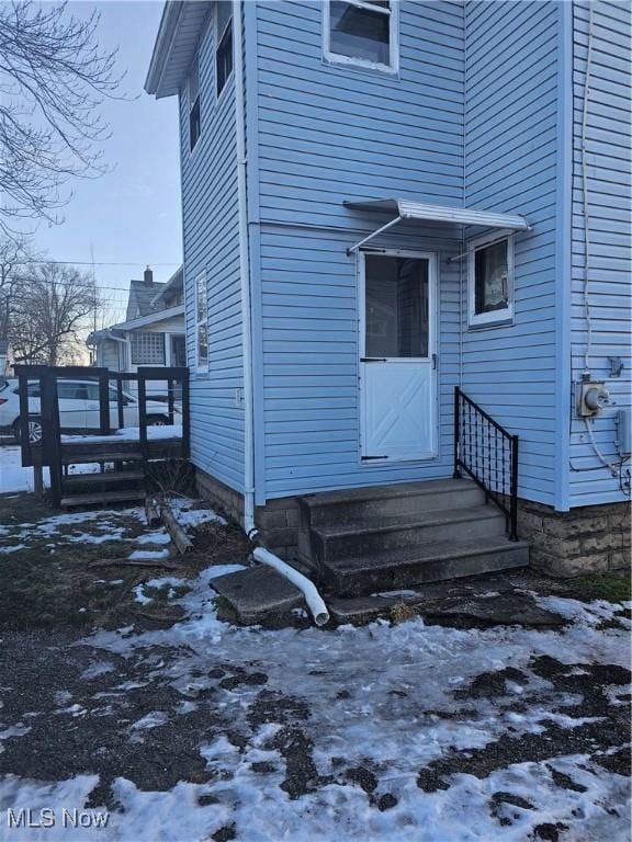 view of snow covered property entrance