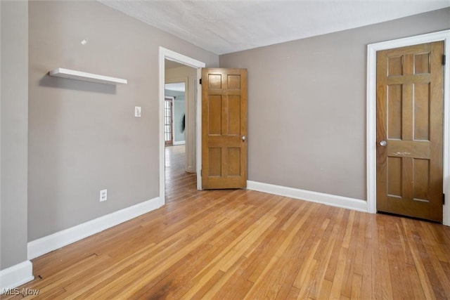 unfurnished room with light wood-type flooring