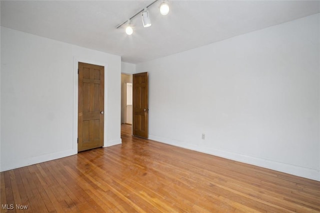 spare room featuring light wood-type flooring