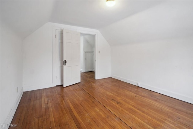 bonus room with hardwood / wood-style flooring and lofted ceiling