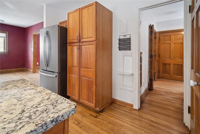 kitchen featuring light hardwood / wood-style floors and stainless steel refrigerator