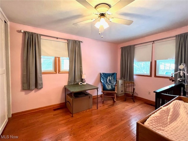 sitting room with hardwood / wood-style flooring, ceiling fan, and plenty of natural light