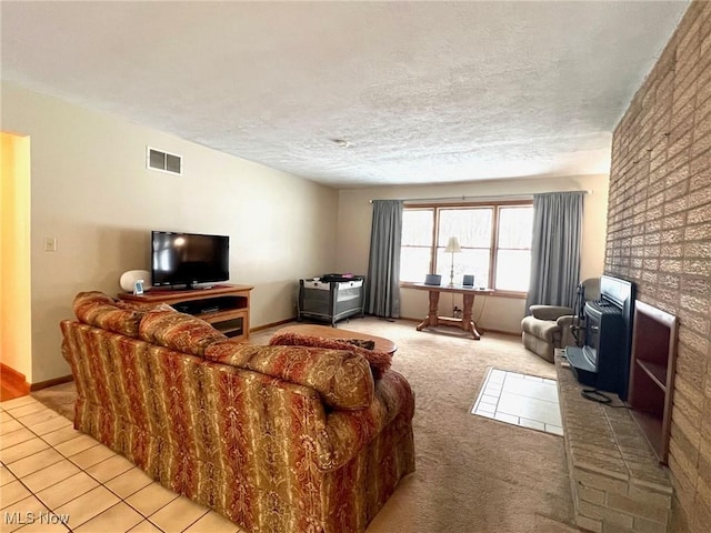 living room with light tile patterned floors and a textured ceiling