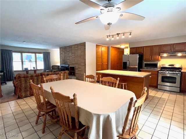 tiled dining room featuring ceiling fan