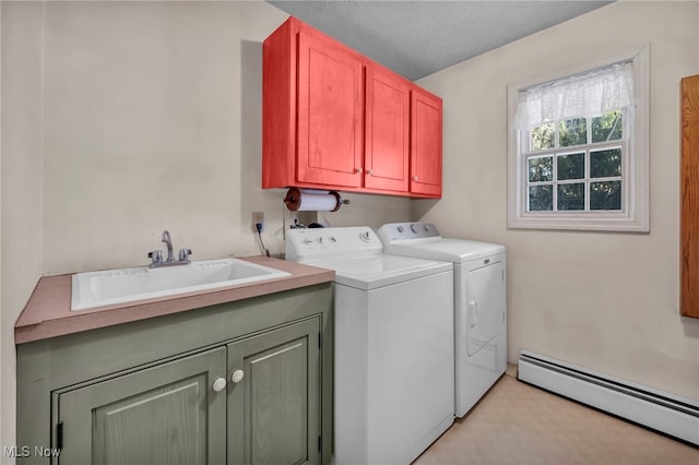 clothes washing area featuring sink, cabinets, a textured ceiling, a baseboard radiator, and washing machine and dryer