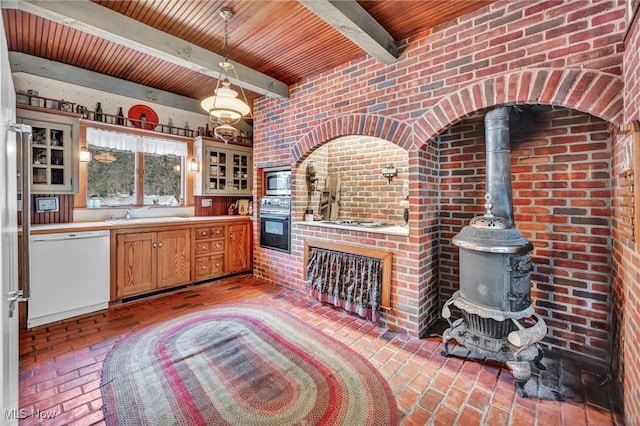 kitchen with white dishwasher, stainless steel microwave, wooden ceiling, oven, and a wood stove