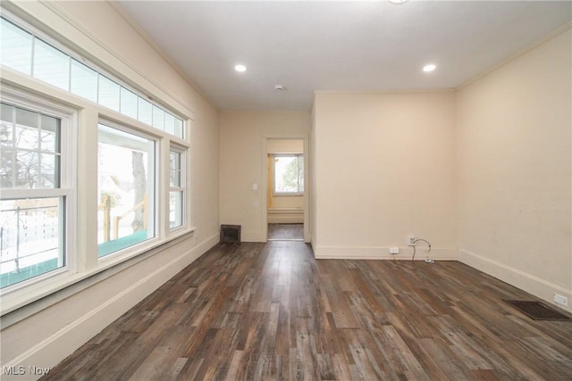 unfurnished room featuring dark hardwood / wood-style flooring and ornamental molding