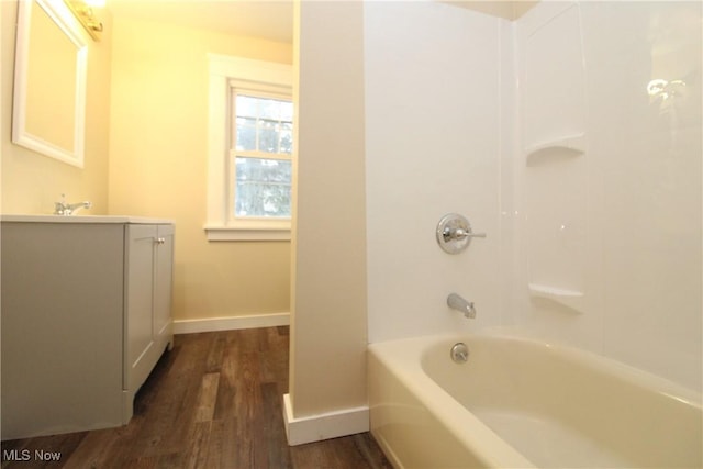 bathroom featuring sink, hardwood / wood-style flooring, and shower / bath combination