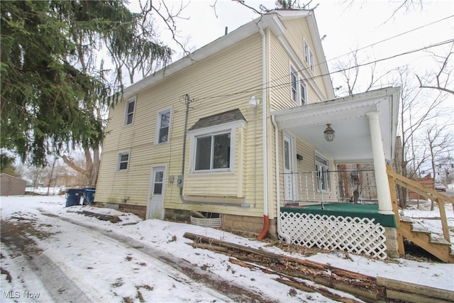 snow covered house with a porch