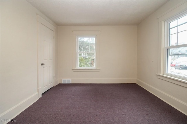 empty room with dark carpet