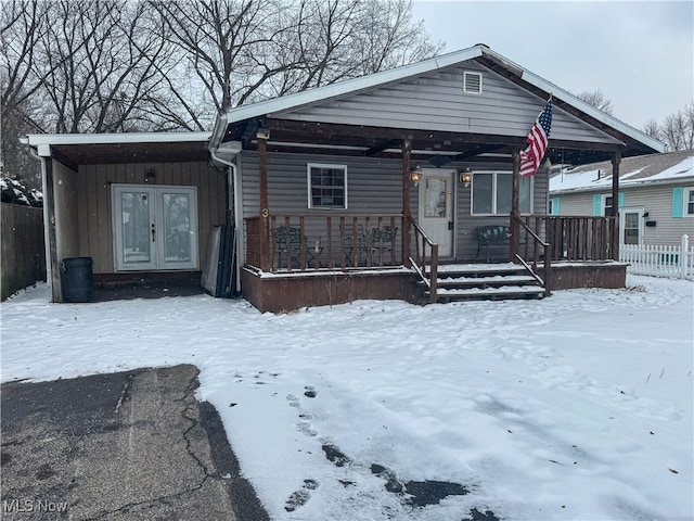 view of front of home featuring a porch, board and batten siding, and french doors