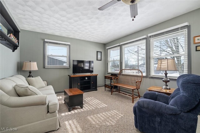 living room with ceiling fan and carpet flooring