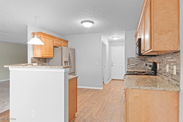 kitchen featuring appliances with stainless steel finishes, light hardwood / wood-style floors, decorative light fixtures, kitchen peninsula, and light brown cabinets