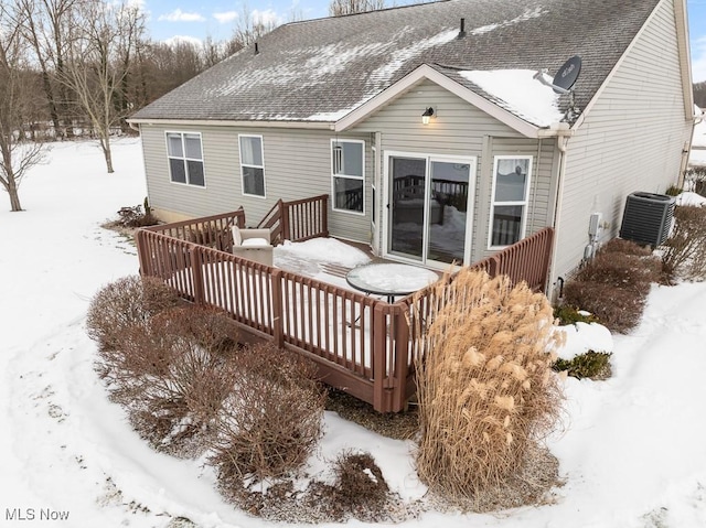 snow covered property featuring a deck and central AC unit