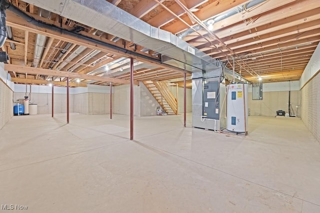 basement featuring heating unit, electric panel, and water heater