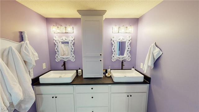 bathroom with vanity and a textured ceiling