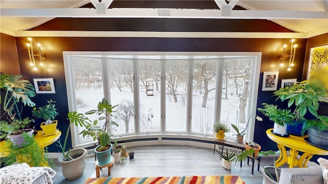 sunroom with vaulted ceiling with beams