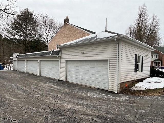 view of side of home with a garage