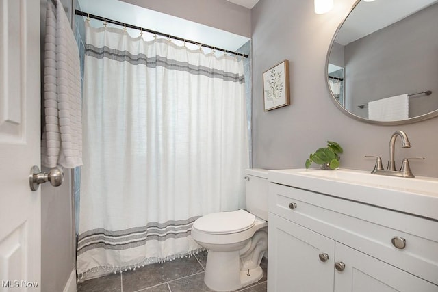 bathroom with tile patterned flooring, vanity, and toilet