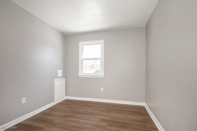 empty room with dark hardwood / wood-style floors