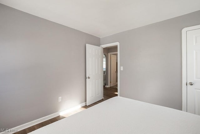 unfurnished bedroom featuring dark hardwood / wood-style floors