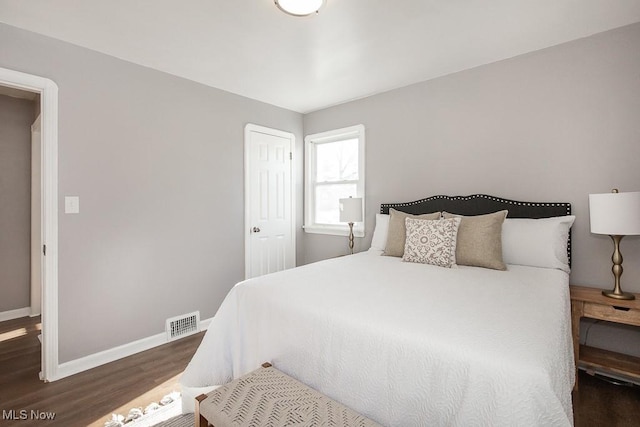 bedroom featuring dark hardwood / wood-style flooring