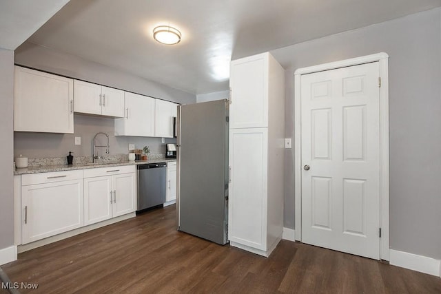 kitchen featuring white cabinetry, stainless steel appliances, dark hardwood / wood-style flooring, and sink