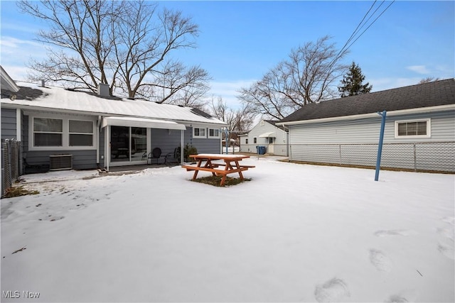 snowy yard with central air condition unit