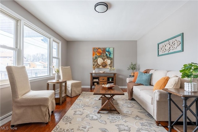 sitting room featuring hardwood / wood-style flooring and a baseboard heating unit