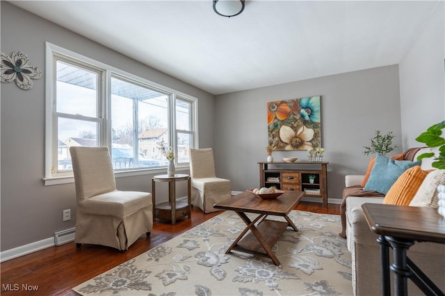 living area with a baseboard radiator and dark hardwood / wood-style floors