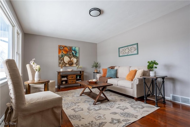 living room with dark hardwood / wood-style flooring