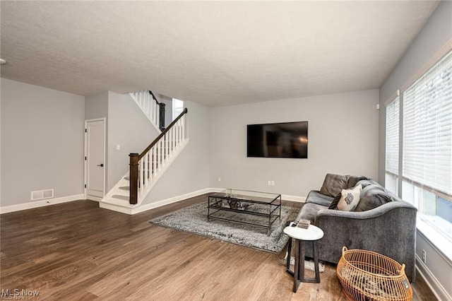 living room with hardwood / wood-style flooring and a textured ceiling