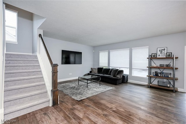 living room featuring plenty of natural light and dark hardwood / wood-style flooring